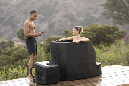 A woman in an Ice Barrel outdoors with a man.