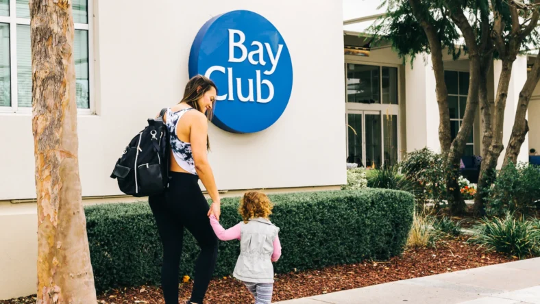 Mother and daughter walking into club