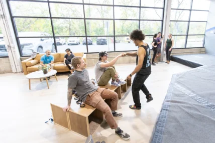 members high-five inside a Central Rock Gym