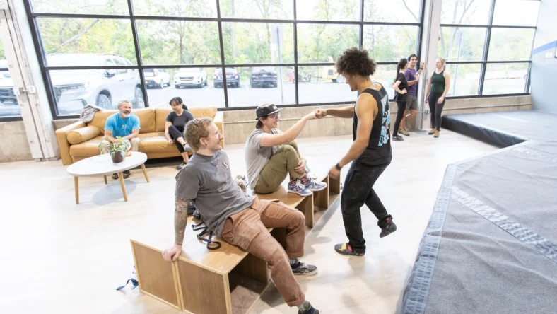 members high-five inside a Central Rock Gym