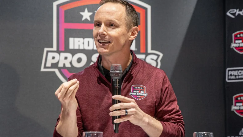 Scott DeRue speaks at an Ironman event