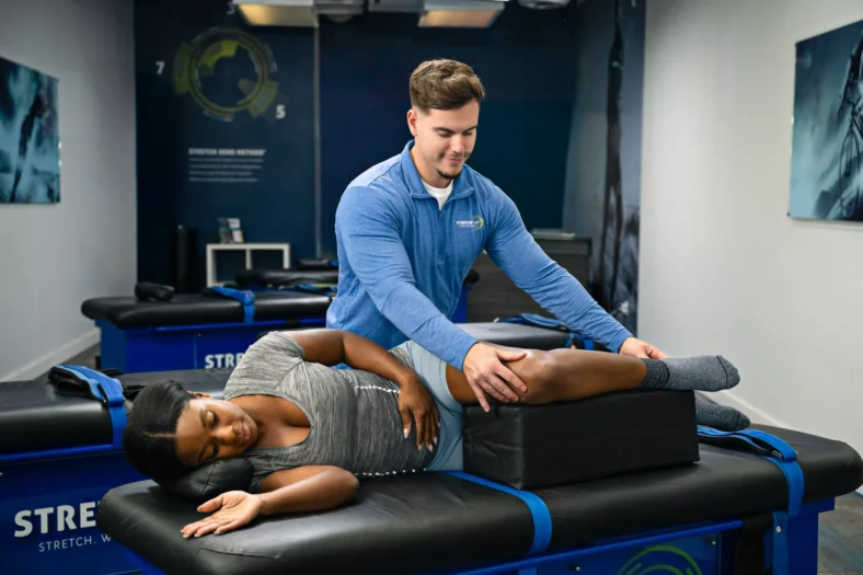 woman gets stretched at a Stretch Zone