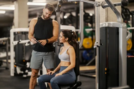 male personal trainer speaks to a female client