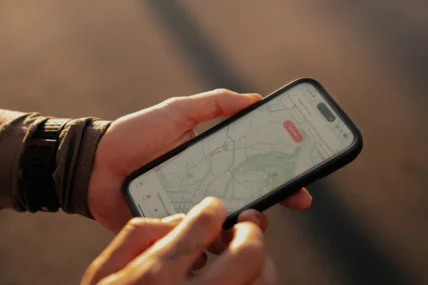 man checks the Strava app on his smartphone