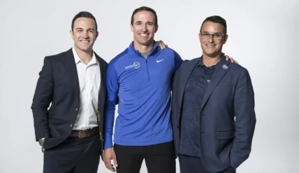 Drew Brees poses with Stretch Zone's Tony Zaccario and Jorden Gold