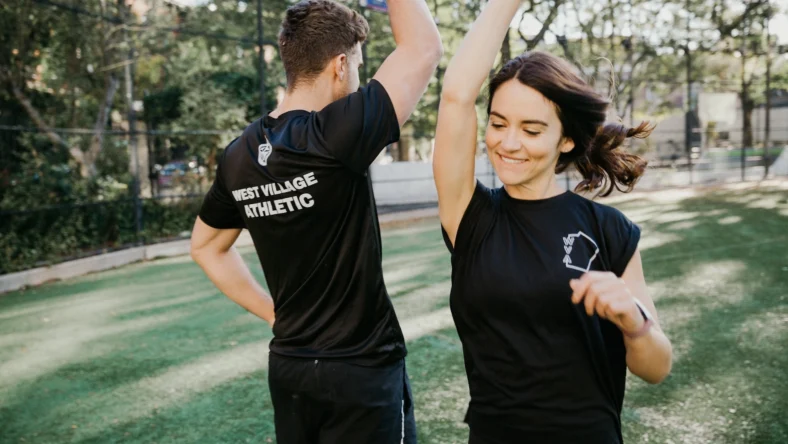 man and woman high five at The Athletic Clubs in West Village